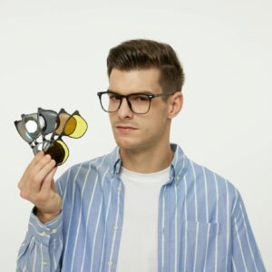 Young male model wearing glasses and a striped shirt, showcasing various eyewear lenses.